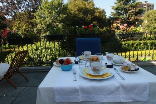 a table with a white table cloth with fruit on it at Lisander B&B suite and terrace in Seregno