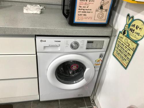 a washing machine in a kitchen next to a counter at 24 Guesthouse Jeonju in Jeonju