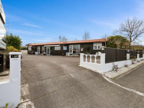 an empty parking lot in front of a house at Dunrovin Motel in Taupo
