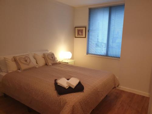 a bedroom with a bed with two folded towels on it at Apartment with a View in Perth