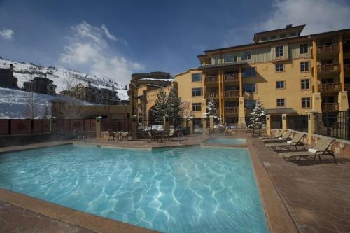 a large swimming pool in front of a building at Sundial - C414 in Park City