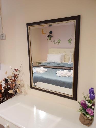 a mirror reflecting a bed in a bedroom at Cana Boutique Hotel in Bangkok