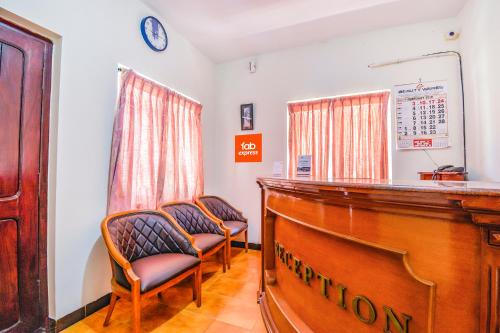 a waiting room with two chairs and a podium at FabExpress Wenlock Homes in Ooty