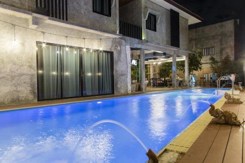 a large swimming pool with a water fountain at ลอฟท์แอทสีมา สาขา2 in Nakhon Ratchasima