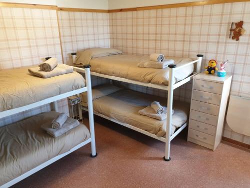 a bedroom with two bunk beds and a dresser at VUT Olimpia in Jaca