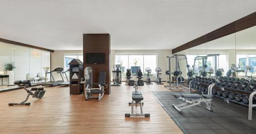a gym with lots of treadmills and exercise machines at Hyatt Place Dubai Jumeirah Residences in Dubai