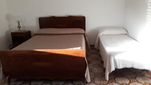 a bedroom with two beds and a night stand at Casa Vacanze nel Verde a 5 Km dal mare in Nettuno