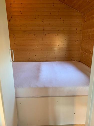 a small sauna with a wooden ceiling and a white floor at Tangloppen Camping & Cottages in Ishøj