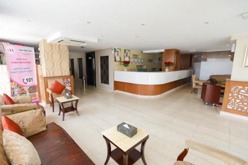 a living room with couches and tables and a counter at ماجيك سويت ابوحليفة Magic Suite Abu Halifa in Kuwait