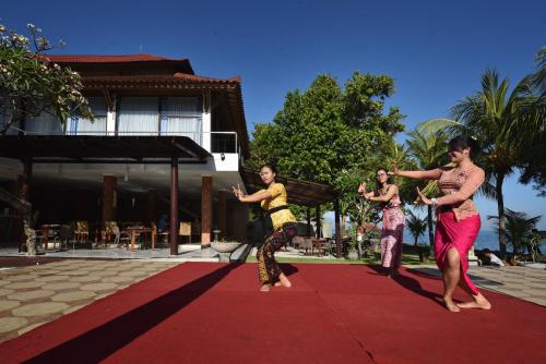 a group of women dancing on a red carpet at Puri Saron Hotel Baruna Beach Lovina in Lovina