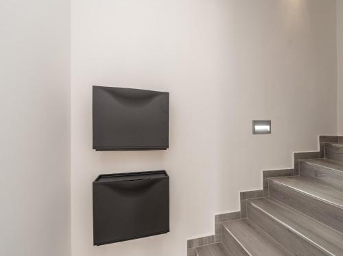 a wall with two black boxes on a wall at Villa Contessa in Privlaka