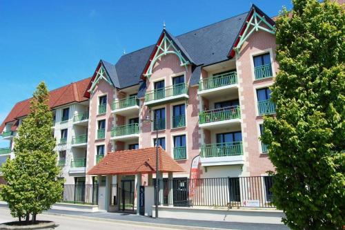 
a large brick building with a large window at Résidence Services Seniors Domitys - Les Safrans in Dives-sur-Mer
