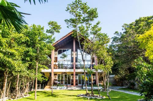 a house in the middle of trees at Edgewater Dive & Spa Resort in Puerto Galera