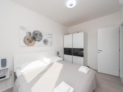 a white bedroom with a large white bed in it at Villa Contessa in Privlaka