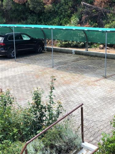 a car parked in a parking lot with a green roof at Ariadni -Villas- luxury houses in Kriopigi
