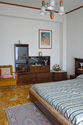 a bedroom with a bed and a dresser and a mirror at DOMUS LACUS in Campolattaro