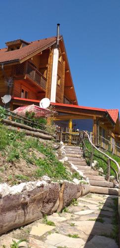 a house with stairs in front of it at Penzión Racibor in Oravský Podzámok