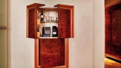 a wooden cabinet with a microwave on a wall at Hotel Alter in Lublin