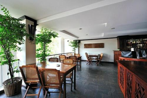 a dining room with tables and chairs in a room at Lao Orchid Hotel in Vientiane