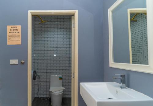 a bathroom with a sink and a toilet and a mirror at Little Paradise Haad Rin Koh Phangan in Haad Rin