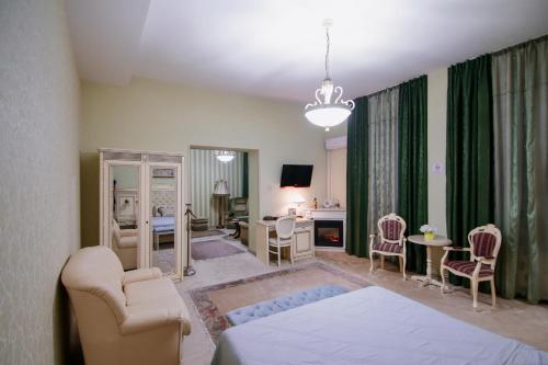 a bedroom with a bed and a living room at Hotel Royal Craiova in Craiova