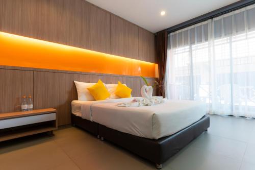a bedroom with a large bed with a large window at Little Paradise Haad Rin Koh Phangan in Haad Rin