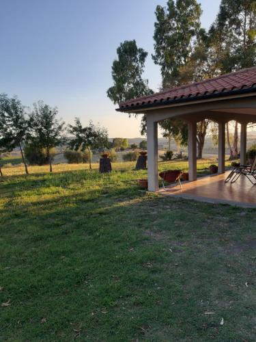 a pavilion in a park with a grass field at Agriturismo Uliveto Gretacci in Montemerano