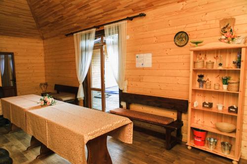 a dining room with a table in a wooden room at Галицька Корона in Lviv