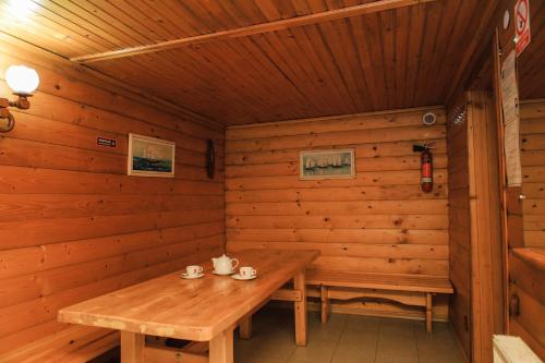 a wooden cabin with a wooden table in it at Галицька Корона in Lviv