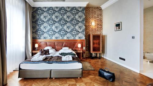 a bedroom with a bed and a brick wall at Hotel Alter in Lublin
