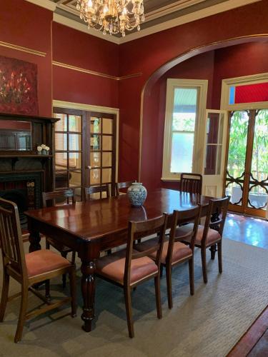 a dining room with a wooden table and chairs at Guildford River Retreat in Perth