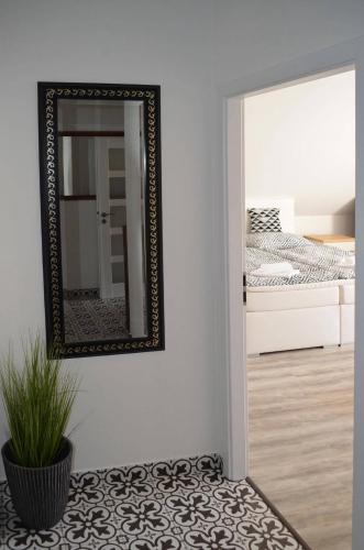 a mirror on a wall next to a bedroom at Hotel Na Baste in Jablonec nad Nisou