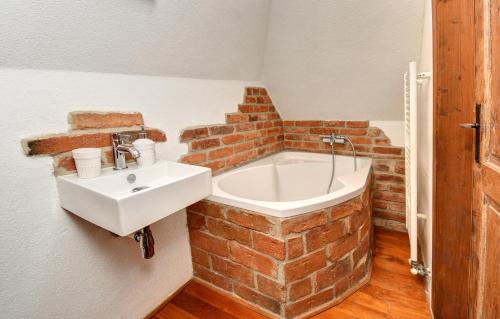 a bathroom with a sink and a brick wall at Apartmán u Brány in Prachatice