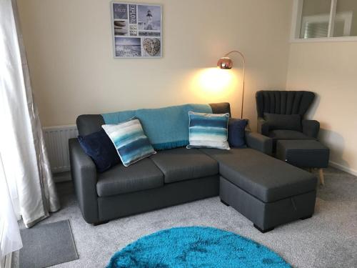 a living room with a couch and a chair at Wristland Court, Watchet in Watchet
