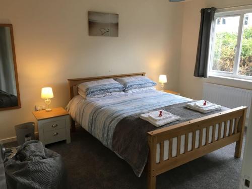 a bedroom with a bed with two towels on it at Wristland Court, Watchet in Watchet