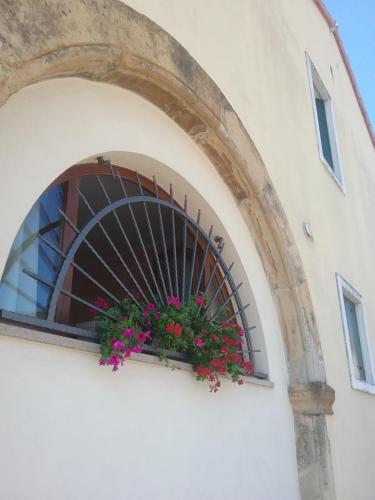 a window with a flower box on the side of a building at SESTO SENSO in Barbarano Vicentino
