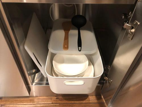 a bathroom with a toilet with a spoon on it at Condominium MIRAHAKONE in Hakone