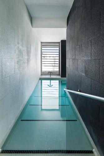 a swimming pool in a room with blue water at Hotel Spa Calagrande Cabo de Gata in Las Negras