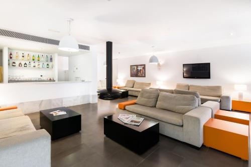 a living room with two couches and a fireplace at Hotel Spa Calagrande Cabo de Gata in Las Negras