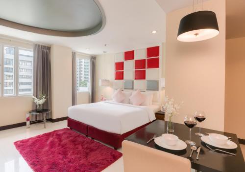 a hotel room with a large bed and a large window at FuramaXclusive Asoke, Bangkok in Bangkok
