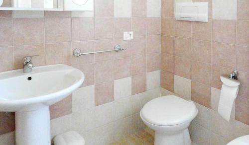 a bathroom with a toilet and a sink at affittacamere S'Ortensia in Mamoiada