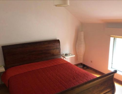 a bedroom with a red bed and a window at Home Brasserie in Wanlin