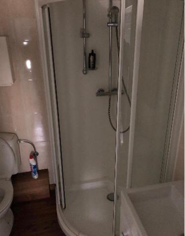 a bathroom with a shower and a toilet at Home Brasserie in Wanlin