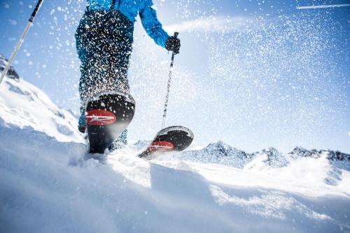 a person standing on skis in the snow at Hotel Jägerhof in Kaunertal