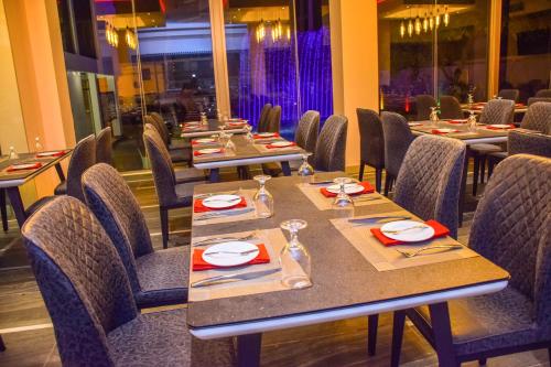 a dining room with long tables and chairs at Ruvisha Beach Hotel in Negombo