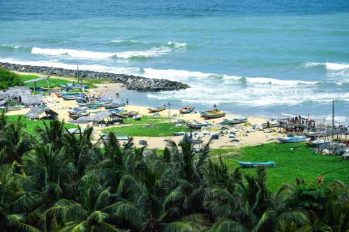 a beach with boats on the sand and the ocean at Ruvisha Beach Hotel in Negombo