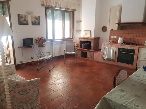 a kitchen with a table and chairs in a room at Casa Vento in Viareggio