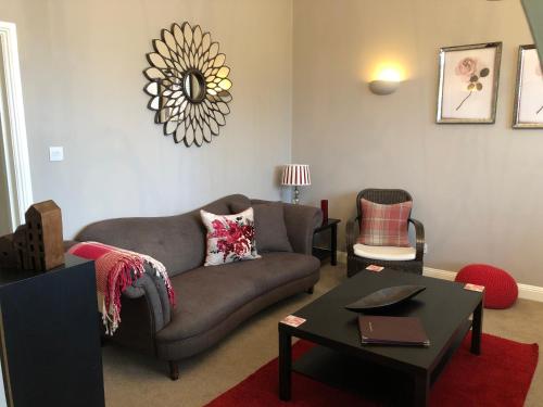 a living room with a couch and a table at Number 10 service apartment - Danes in Southampton