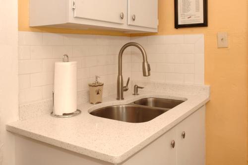 a kitchen counter with a sink and a roll of paper towels at Adorable Historic Downtown Apartment in St. Augustine