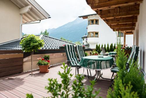 a patio with a table and chairs on a balcony at Appartement Stern Dagmar in Neustift im Stubaital